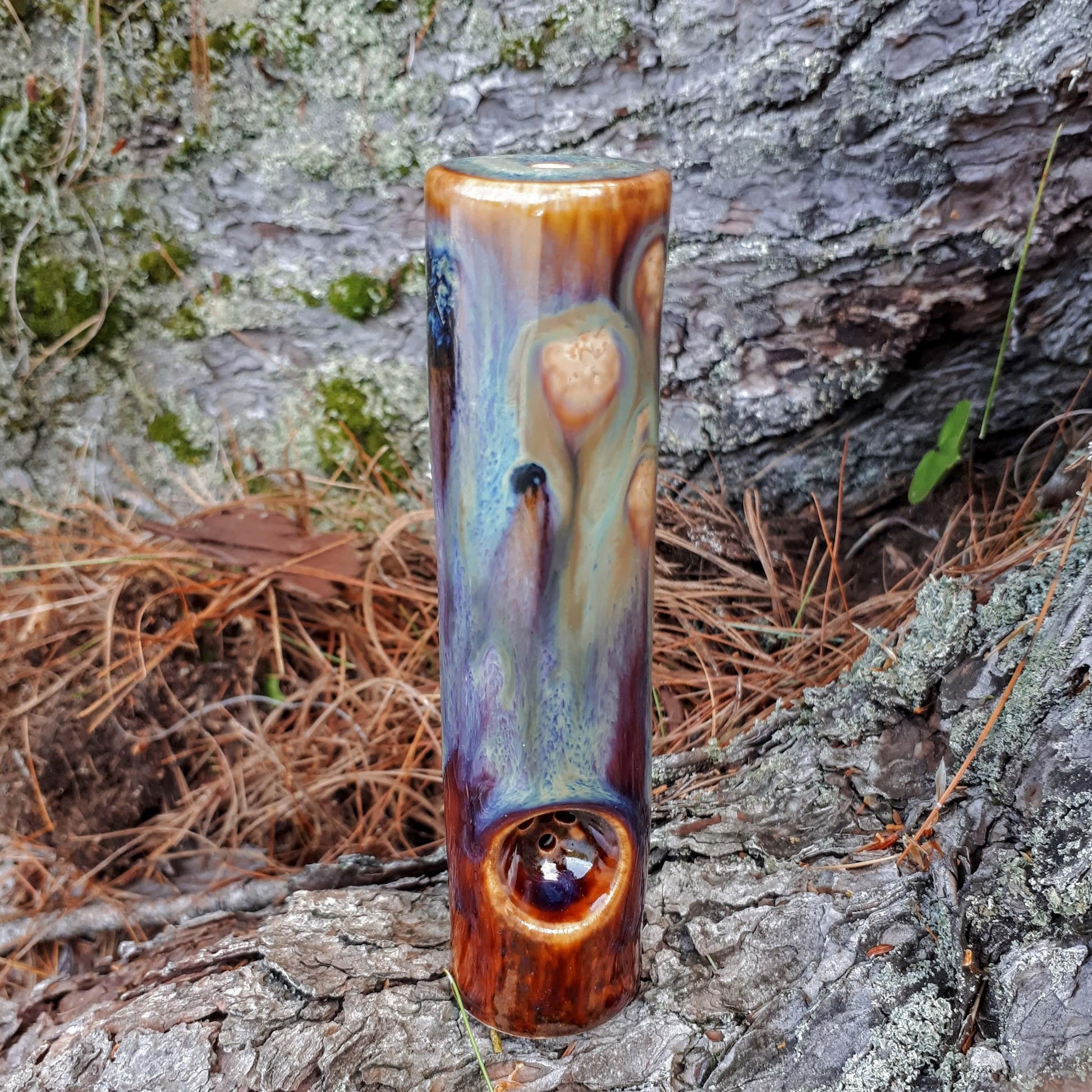 Dirty peacock original cannabis pipe on tree