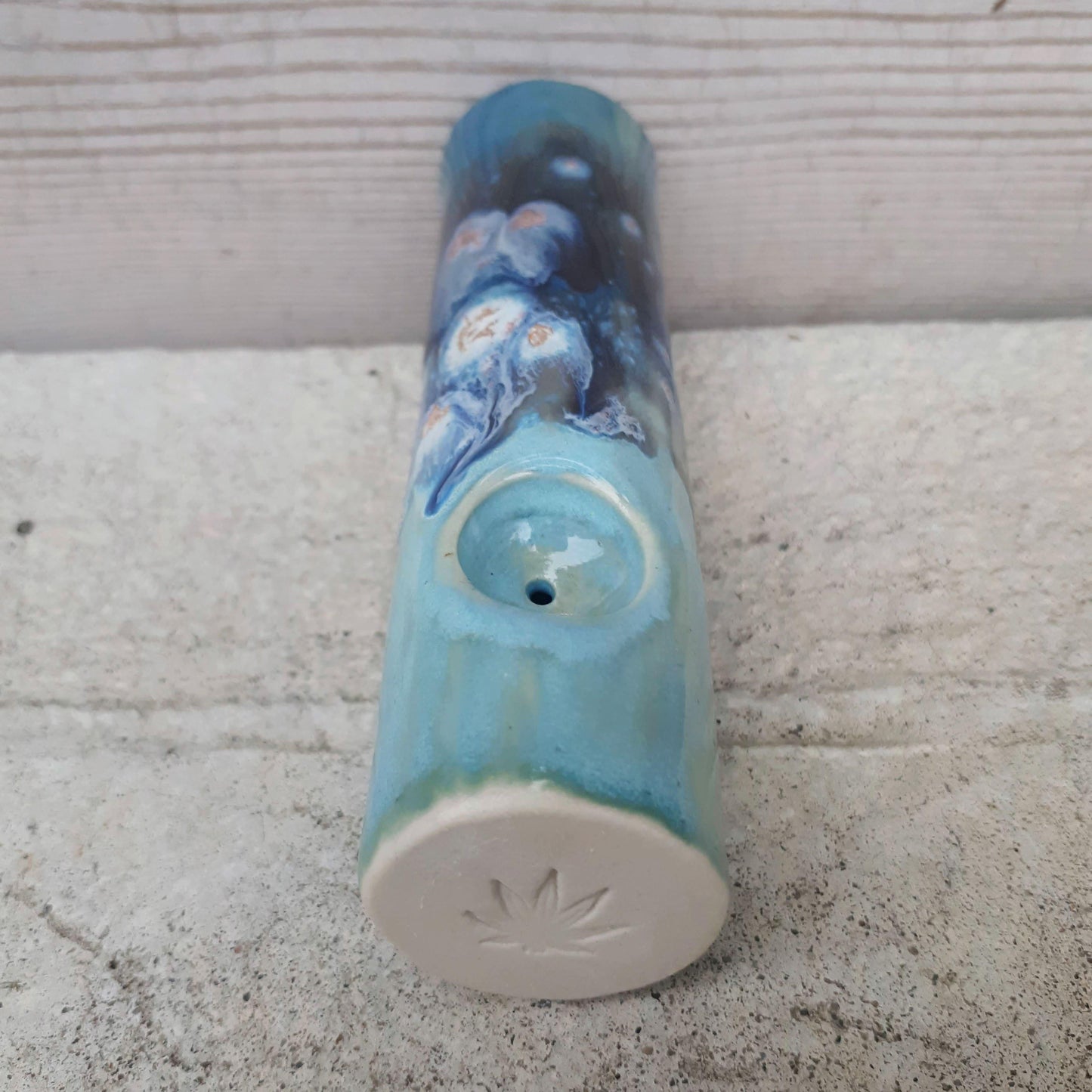 Blue Dream original cannabis pipe, looking at the end with stamped leaf on unglazed end