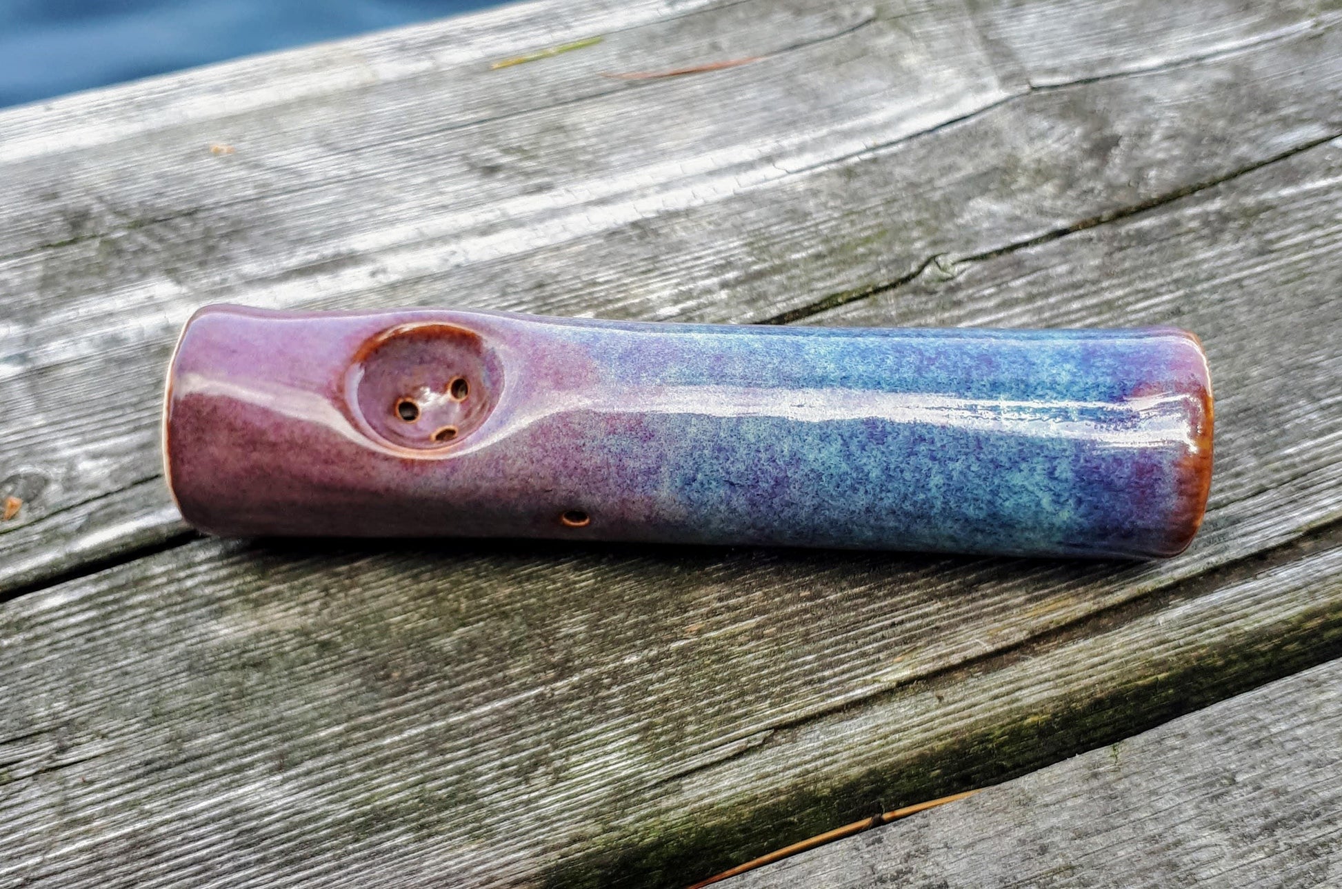 blue rain original cannabis pipe on dock, blue and purple