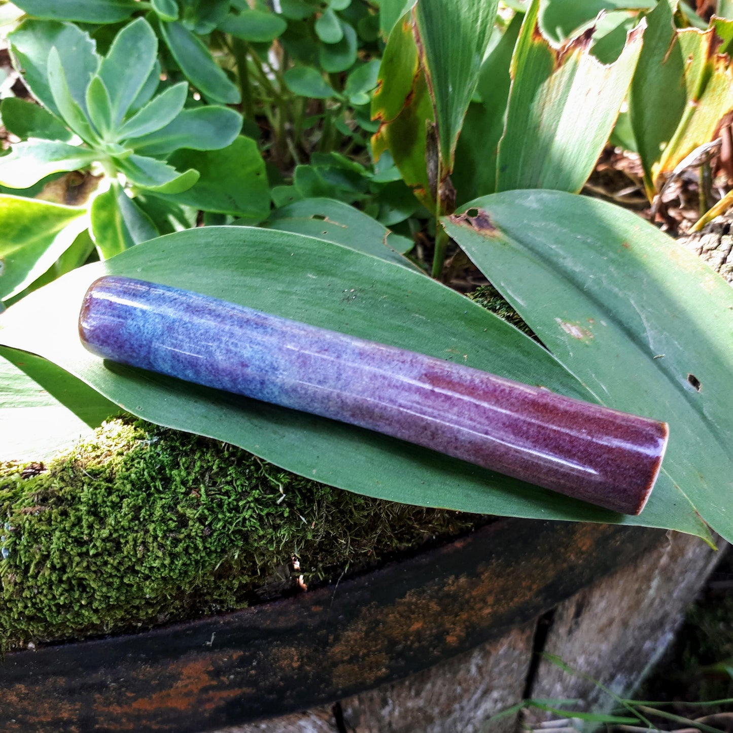 Blue Rain uno chillum side view on leaf in garden