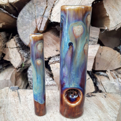 Dirty peacock original cannabis pipe and uno chillum on wood pile